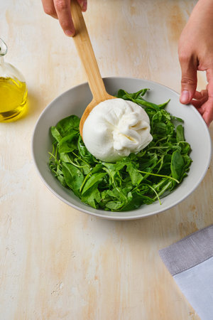 Step-by-step instructions for preparing a summer salad with peach, ricotta, burrata, and ham on a light concrete background. Step-by-step recipes. Salad recipes.