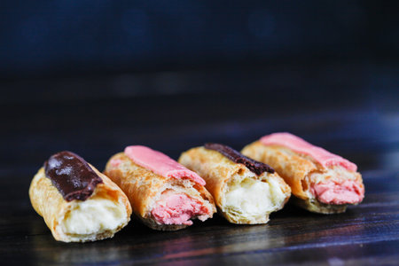 Eclairs on a wooden background