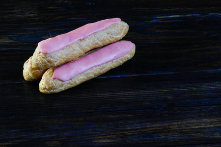Eclairs on a wooden backgroundの写真素材