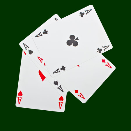 A winning poker hand of four aces playing cards suits on green