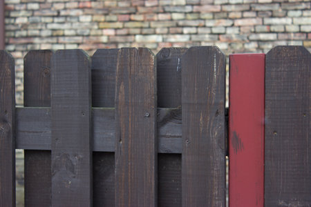 wooden fence over the brick backgroynd  の写真素材