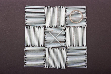 Nails on black background, close up ,background of small iron nails,Tic Tac Toe Game 