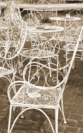 Street view of a coffee terrace with tables and chairsの写真素材