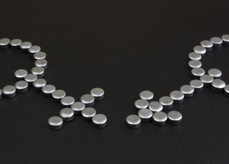 symbols done from small metal details on textured black background  の写真素材