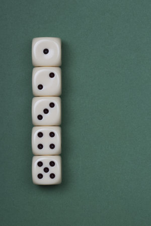 five white dices on the green backgroundの写真素材