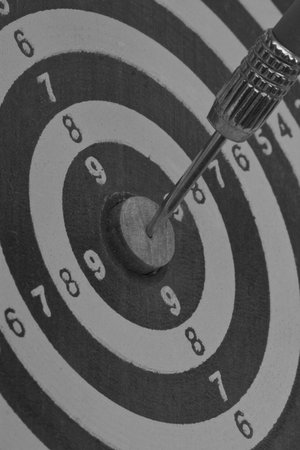 the dart hitting the middle of dartboard, close up  の写真素材