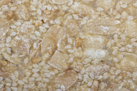 Close shot of sesame seeds and nuts in syrup, food background, Sesame Seed Honey Bar の写真素材