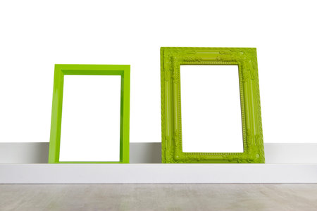 green picture frames on the shelf