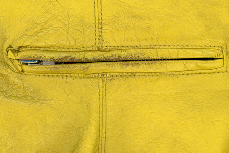 Extreme close up shot of yellow old hand bag zipperの写真素材