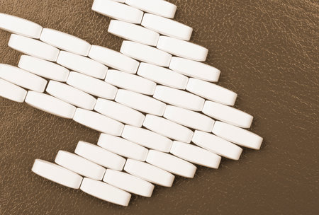 Arrow sign made from Pills of Drugs on brown backgroundの写真素材