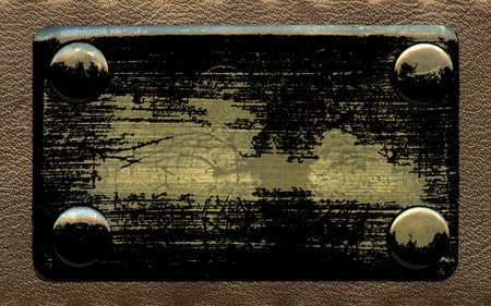 old blackened metal label on leather backgroundの写真素材
