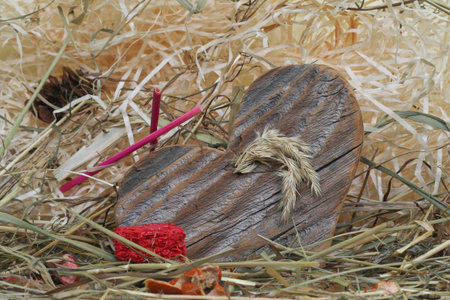 Wooden heart on straw background, decorated