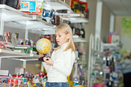 Woman buys school supplies. Girl chooses school suppliesの写真素材