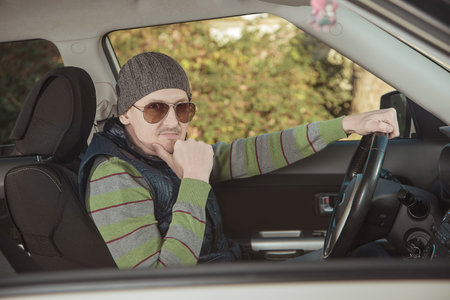 man behind the wheel of a new car