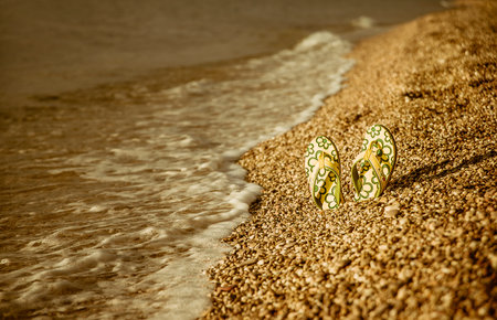 flip flops in the sand on the beach.summerの写真素材