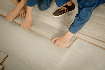 Installation laminate. focus on the hand. Man puts laminateの写真素材
