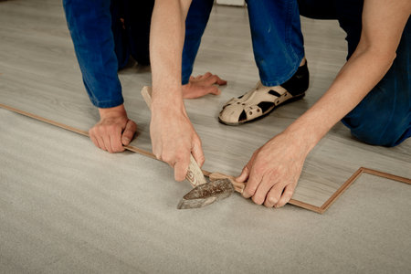 Installation laminate. focus on the hand. Man puts laminateの写真素材