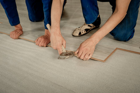 Installation laminate. focus on the hand. Man puts laminateの写真素材