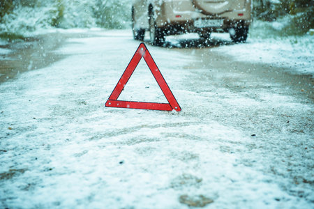 Red emergency sign on winter roadの写真素材