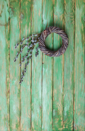 Easter wreath and willow branches on a wooden backgroundの写真素材