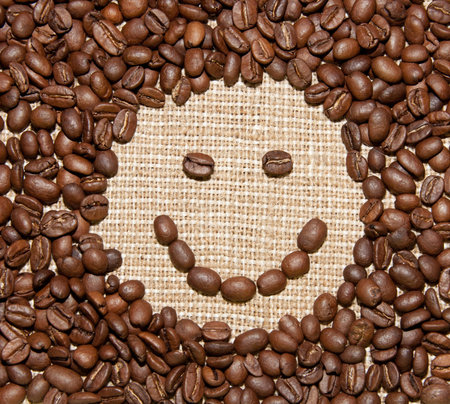 coffee beans smile on burlap backgroundの写真素材