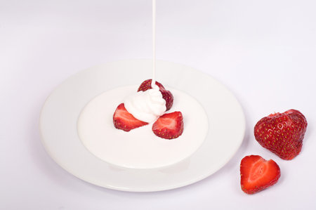 sweet strawberry with sour cream on white plateの写真素材