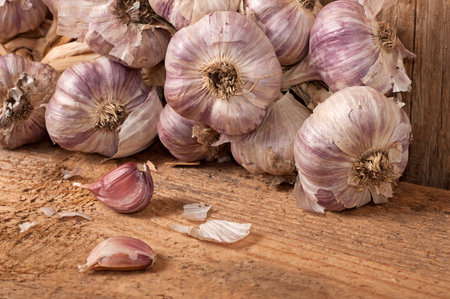 Garlic on old wooden table, close upの写真素材