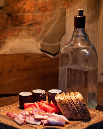 Vodka with bread, bacon and tomatoの写真素材