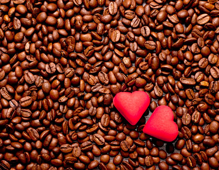 two red hearts on coffee beans, love conceptの写真素材