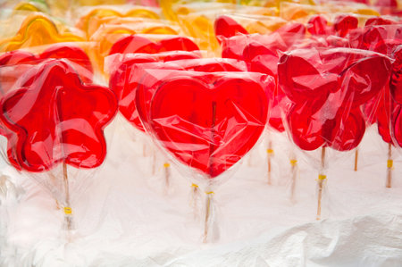 red heart-shaped lollipops sold in the parkの写真素材