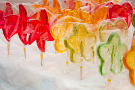 many colorful lollipops sold on white tableの写真素材