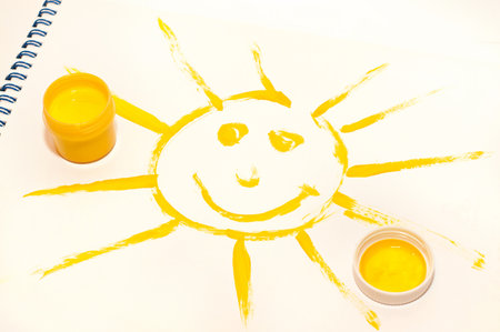 the smile yellow sun painted on white backgroundの写真素材