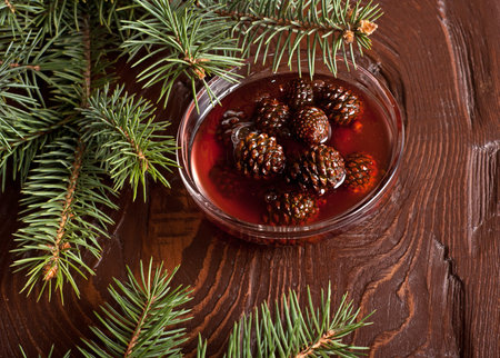 The Jam from fir cones in dish on wooden tableの写真素材