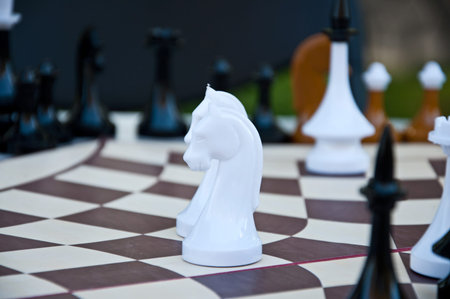 Chess game. White, black and brown Chess pieces on the hexagonal board for three players. Russian...