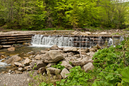 The dam across a mountain river. Carpathians mountains in Ukraineの写真素材
