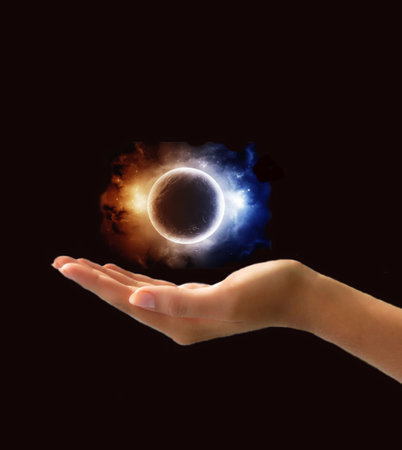 shiny blue and orange planet in handの写真素材