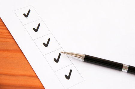 Blank checklist on a wooden tableの写真素材