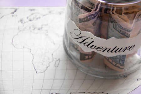 A glass jar with money put aside for a holiday with the inscriptionの写真素材