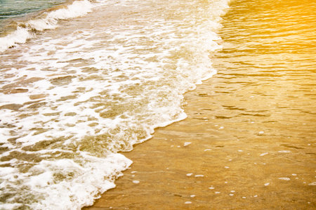 Soft wave of blue ocean on a sandy beach. With the blur. Toning.の写真素材