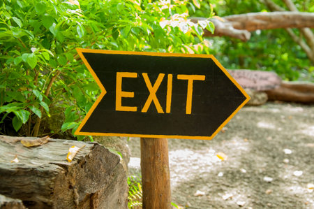 The sign of the exit is written in yellow ink on a black background, set in the parkの写真素材