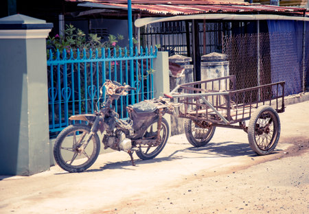 Motobike in the Vietnamese village, adapted for cargo transportation. A picturesque village street. With toningの写真素材