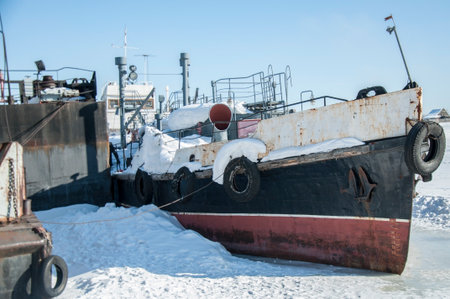 Old ship Stands on the pier Is frozen in ice With blurの写真素材