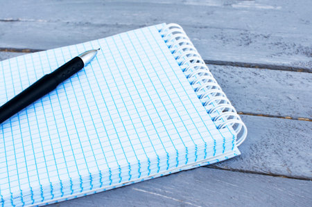 A notepad in a box for entries on a wooden table.
