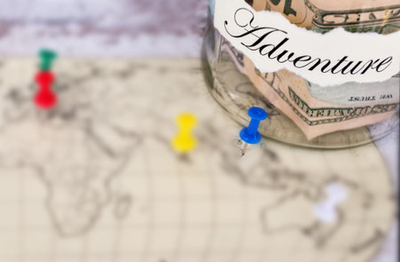 The glass bank with the money is postponed to the holiday with the inscription Adventures. With the...
