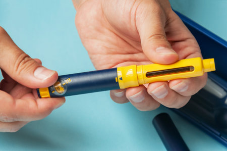 A man holds a syringe for subcutaneous injection of hormonal drugs in the IVF protocol (in vitro...