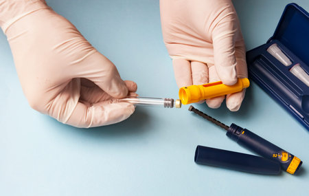A man in medical gloves holds a syringe for subcutaneous injection of hormonal drugs in the IVF...
