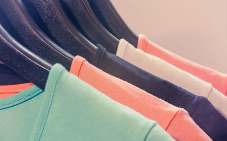 Hangers for clothes in black, on which hang colorful things.