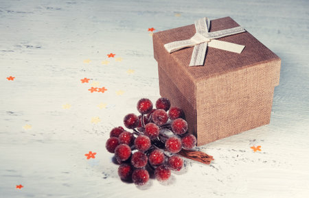 A brown gift box and a beige ribbon with a tag on a light background. A Christmas gift.Toning and blur.の写真素材