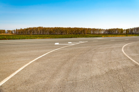 The picturesque landscape and the Sunrise over the road. Asphalt road with marking. With the blur and bright sunlight.の写真素材