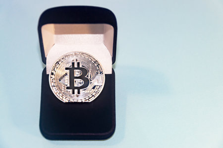 Coin bitcoin in a gift box for a ring or jewelry. The concept of crypto currency. The best gift for the holiday. A gift in Christmas. On blue background.の写真素材